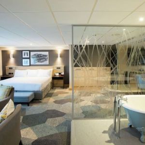 Spacious day use room with living area and tub at DoubleTree By Hilton Coventry Building Society Arena.