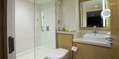 Guest bathroom with shower at DoubleTree By Hilton Coventry Building Society Arena.