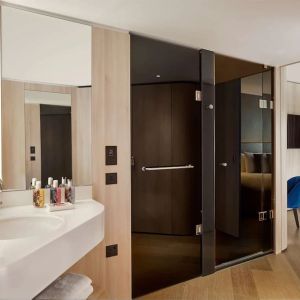 Guest bathroom with shower at The Westminster London, Curio Collection By Hilton.
