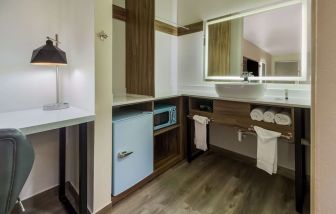 Day use room with mini-fridge and private bathroom at Signature Inn Houston Galleria.