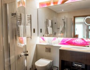 Guest bathroom with shower at Hilton London Heathrow Airport Terminal 5. 