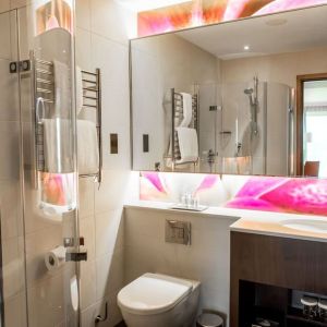 Guest bathroom with shower at Hilton London Heathrow Airport Terminal 5. 