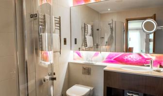 Guest bathroom with shower at Hilton London Heathrow Airport Terminal 5. 