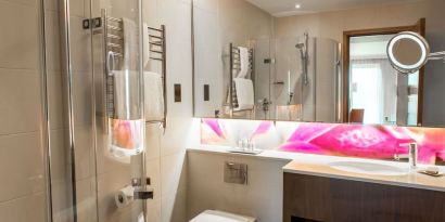 Guest bathroom with shower at Hilton London Heathrow Airport Terminal 5. 