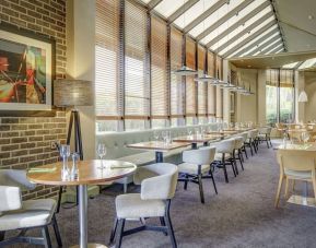 Spacious dining room with natural light at DoubleTree By Hilton Manchester Airport.