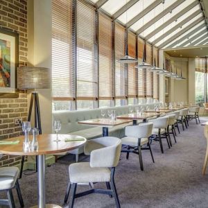 Spacious dining room with natural light at DoubleTree By Hilton Manchester Airport.