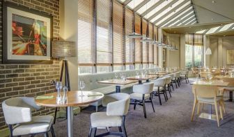 Spacious dining room with natural light at DoubleTree By Hilton Manchester Airport.