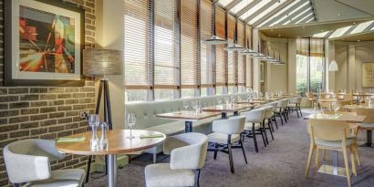 Spacious dining room with natural light at DoubleTree By Hilton Manchester Airport.