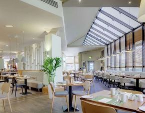 Spacious dining room with natural light at DoubleTree By Hilton Manchester Airport.