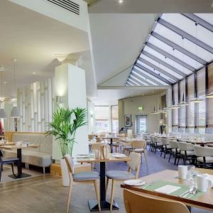 Spacious dining room with natural light at DoubleTree By Hilton Manchester Airport.