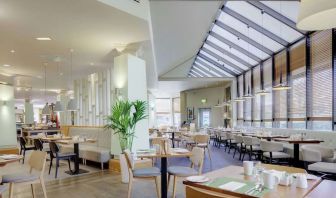 Spacious dining room with natural light at DoubleTree By Hilton Manchester Airport.