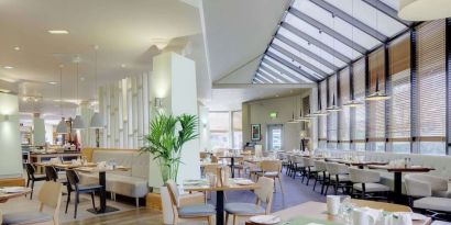 Spacious dining room with natural light at DoubleTree By Hilton Manchester Airport.