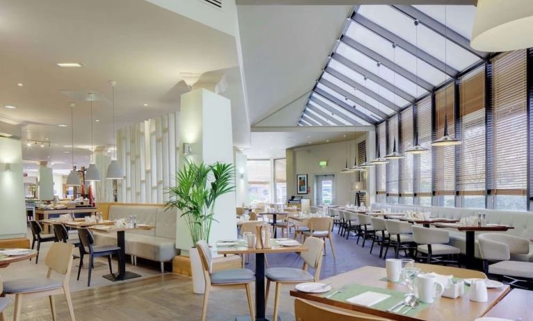 Spacious dining room with natural light at DoubleTree By Hilton Manchester Airport.