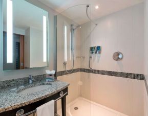 Guest bathroom with shower at Hampton By Hilton London Luton Airport.