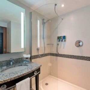 Guest bathroom with shower at Hampton By Hilton London Luton Airport.