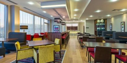 Dining area perfect for coworking at Hampton By Hilton London Luton Airport. 