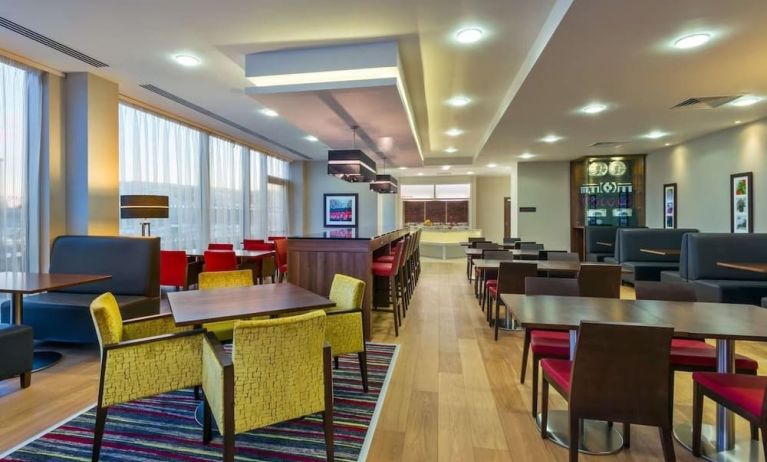 Dining area perfect for coworking at Hampton By Hilton London Luton Airport. 