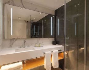 Guest bathroom with shower at Hilton London Metropole. 