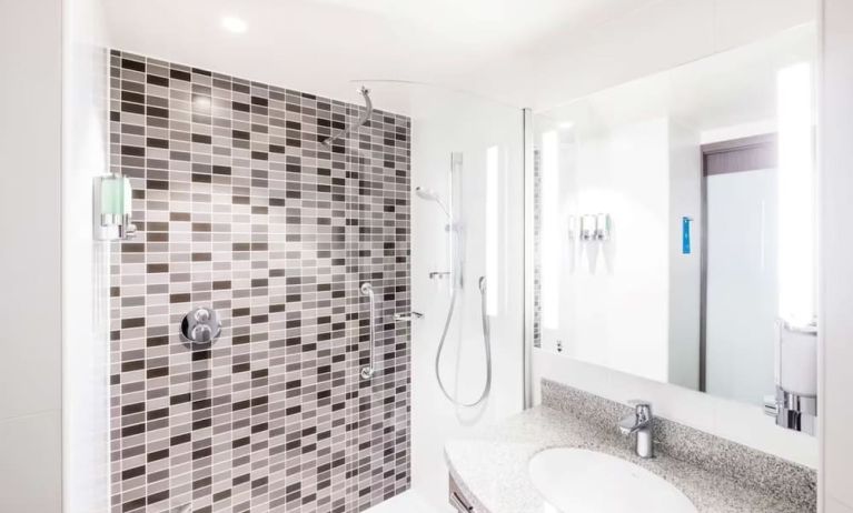 Guest bathroom with shower at Hampton By Hilton Hamilton Park. 