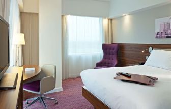 Hotel room with TV and workspace at Hampton By Hilton London Gatwick Airport.