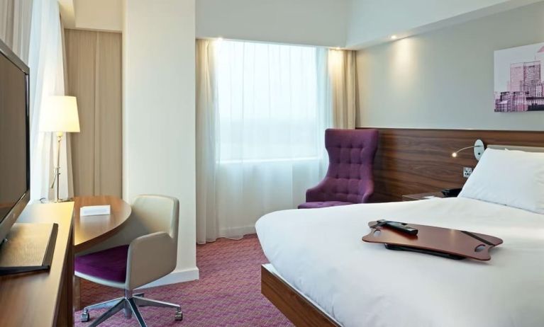 Hotel room with TV and workspace at Hampton By Hilton London Gatwick Airport.