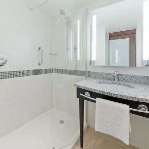 Private bathroom with shower and bath at Hampton By Hilton London Gatwick Airport.