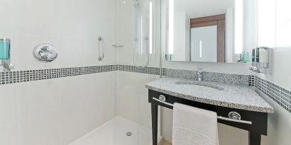 Private bathroom with shower and bath at Hampton By Hilton London Gatwick Airport.