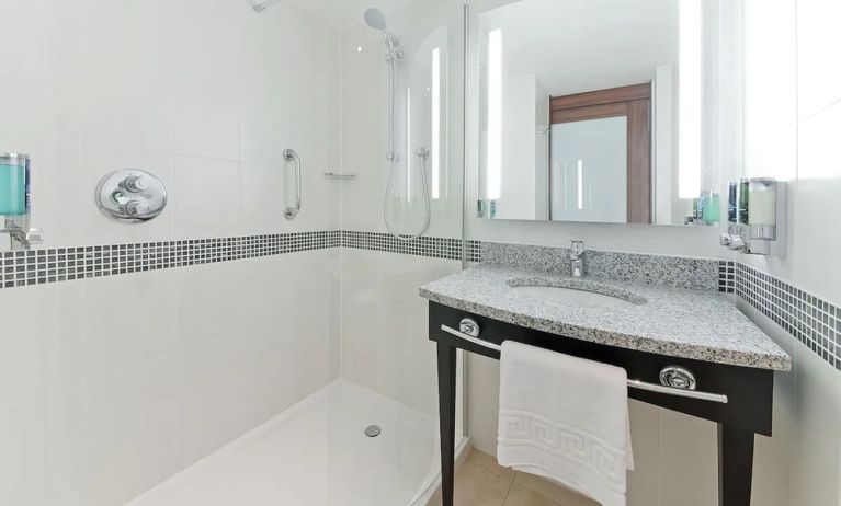 Private bathroom with shower and bath at Hampton By Hilton London Gatwick Airport.