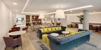 Coworking space and lounge at Hampton By Hilton London Stansted Airport.