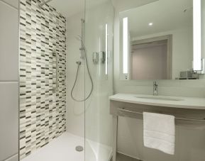 Guest bathroom with shower at Hampton By Hilton Leeds City Centre.