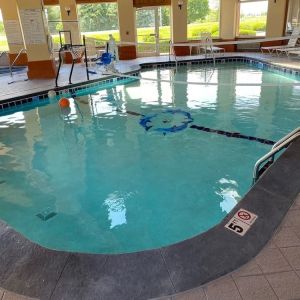 Indoor pool with natural light at Baymont By Wyndham Pella.