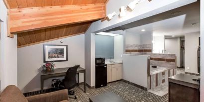 Day room with kitchen and lounge area at Baymont By Wyndham Pella.