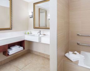 Guest bathroom with tub at DoubleTree By Hilton Sunrise.