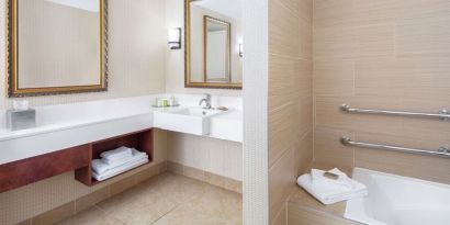 Guest bathroom with tub at DoubleTree By Hilton Sunrise.