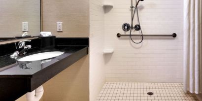 Guest bathroom with shower at Fairfield Inn & Suites By Marriott Tallahassee Central.