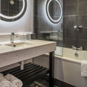 Guest bathroom with shower and tub at DoubleTree By Hilton Bristol South - Cadbury House.