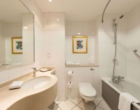 Guest bathroom with shower at Doubletree by Hilton Glasgow Strathclyde. 