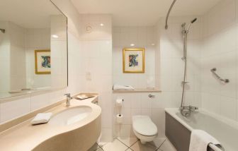 Guest bathroom with shower at Doubletree by Hilton Glasgow Strathclyde. 