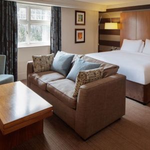 King bed with sofa at DoubleTree By Hilton Stratford-upon-Avon.