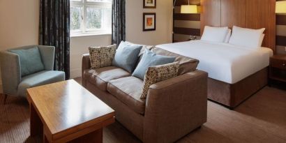 King bed with sofa at DoubleTree By Hilton Stratford-upon-Avon.