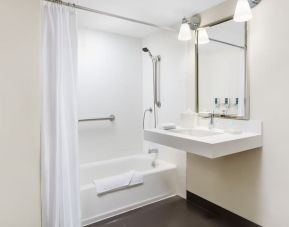 Guest bathroom with shower and tub at Four Points By Sheraton Los Angeles International Airport.