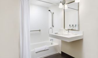 Guest bathroom with shower and tub at Four Points By Sheraton Los Angeles International Airport.