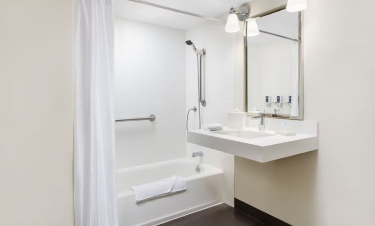 Guest bathroom with shower and tub at Four Points By Sheraton Los Angeles International Airport.