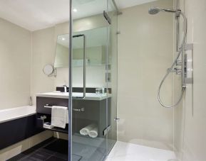 Guest bathroom with shower at Hilton London Heathrow Airport.