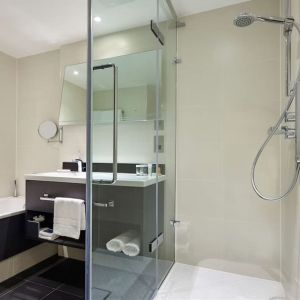 Guest bathroom with shower at Hilton London Heathrow Airport.