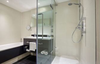 Guest bathroom with shower at Hilton London Heathrow Airport.