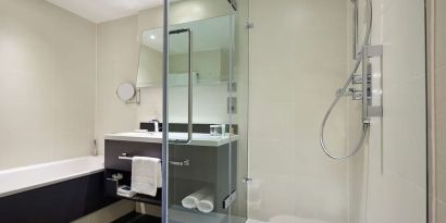 Guest bathroom with shower at Hilton London Heathrow Airport.