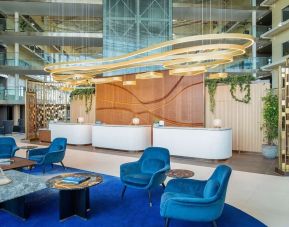 Stylish lobby and coworking lounge at Hilton London Heathrow Airport.