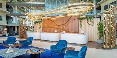 Stylish lobby and coworking lounge at Hilton London Heathrow Airport.