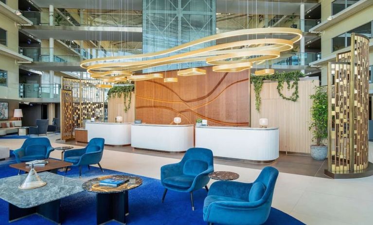 Stylish lobby and coworking lounge at Hilton London Heathrow Airport.